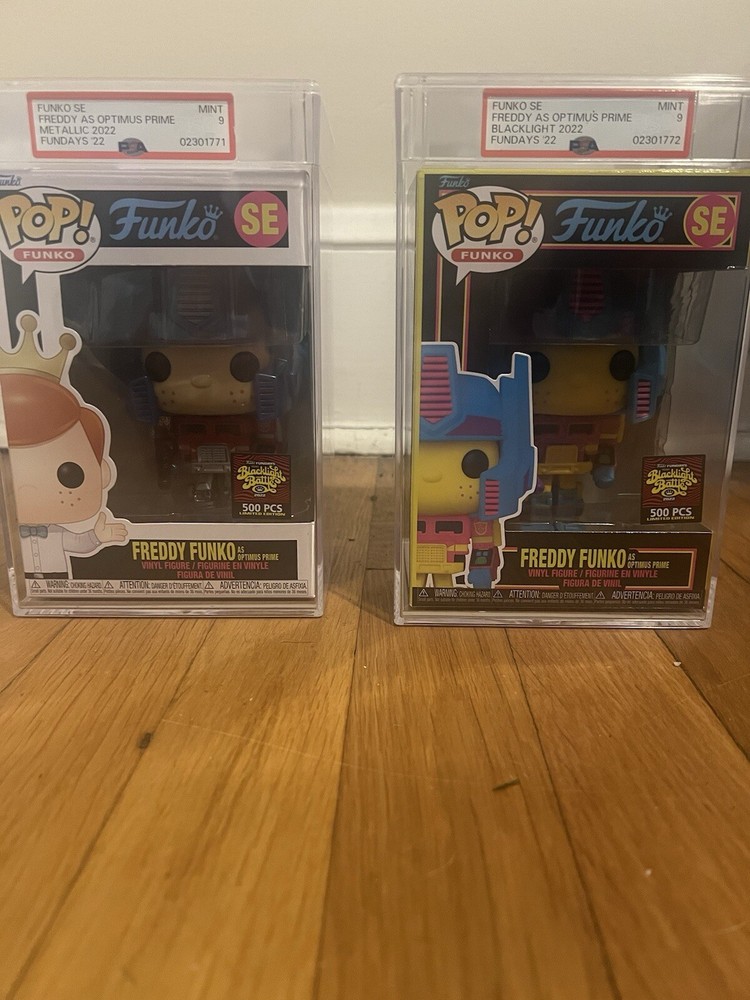 Freddy Funko As Optimus Prime /500 Black light And Metallic Graded Mint 9