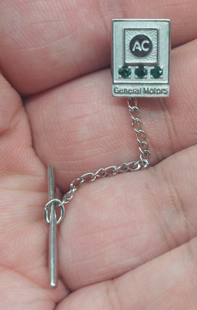 1/10th 10kt General Motors AC Pin with 3 Emeralds