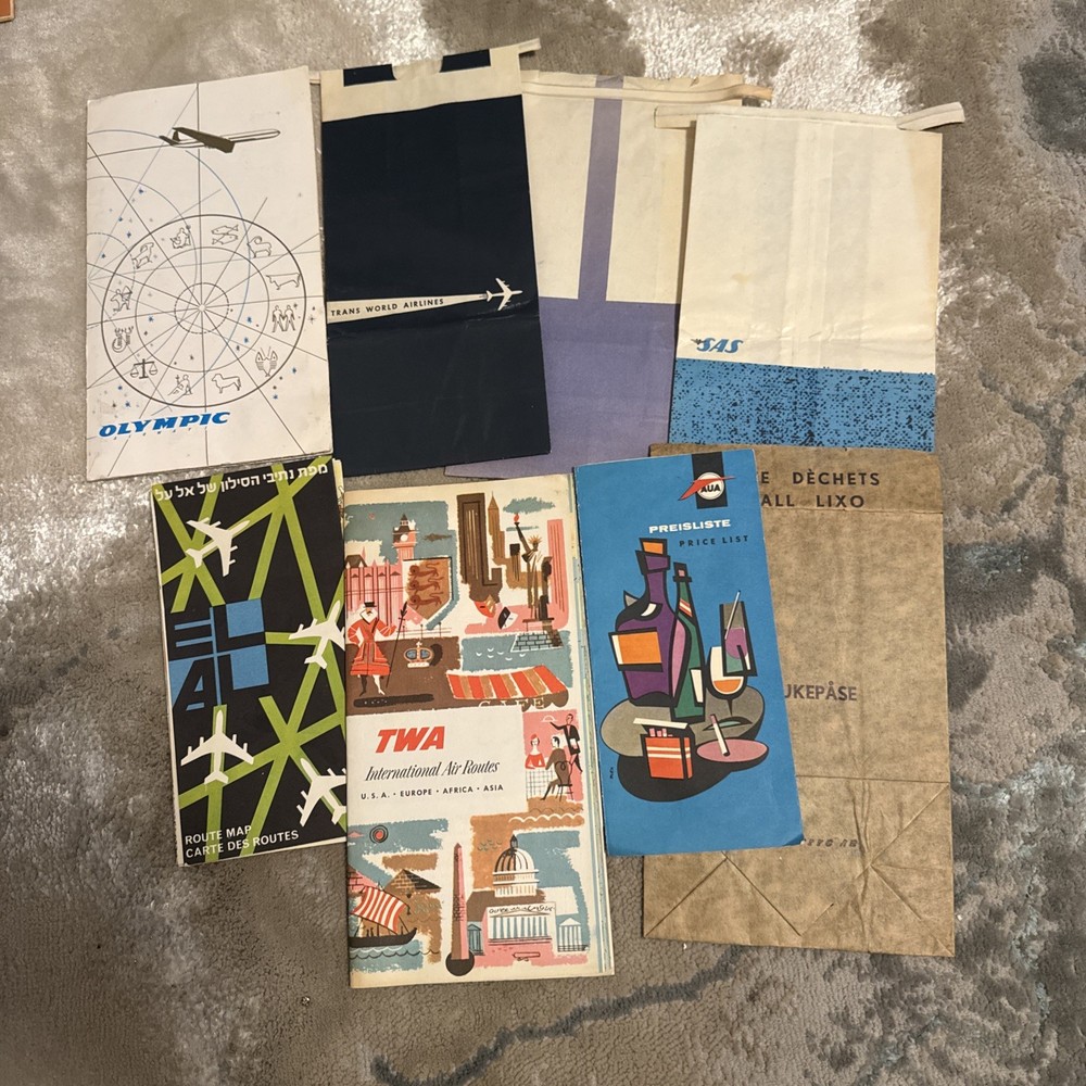 collection of vintage airline memorabilia maps, ticket jackets, airsickness bags