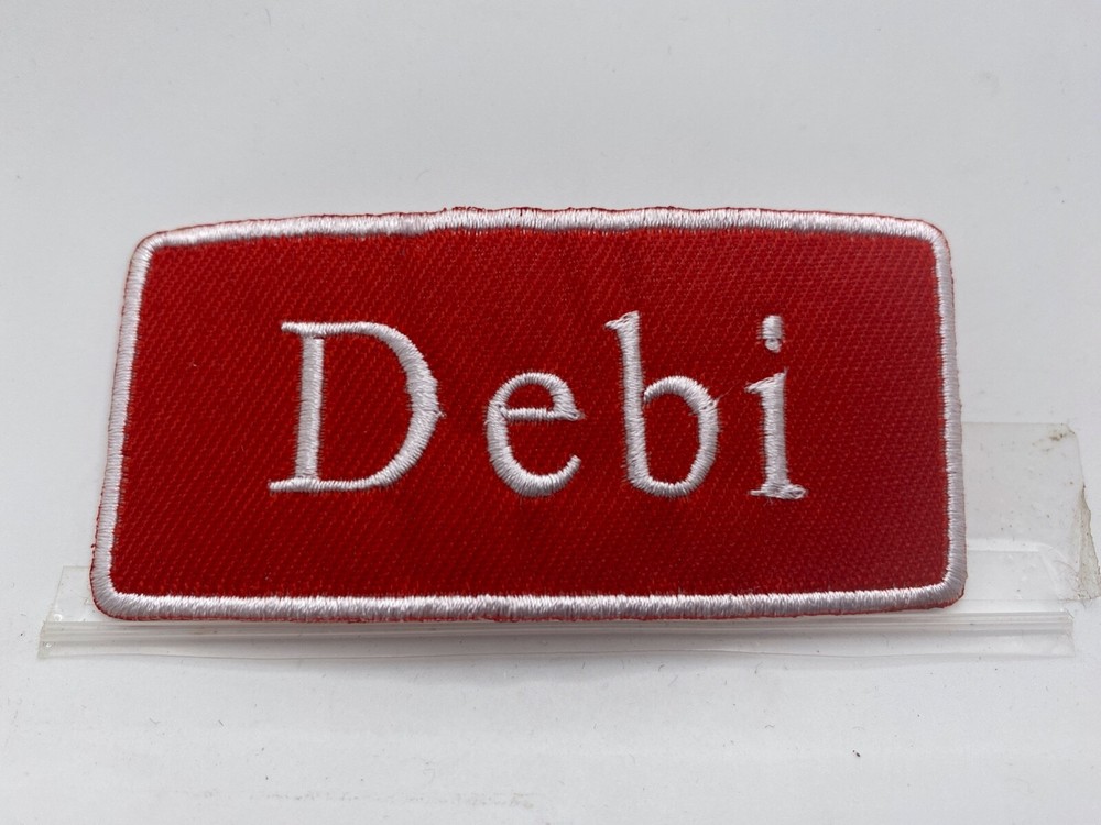 DEBI  NEW EMBROIDERED   IRON ON NAME PATCH WHITE ON RED  1-1/2 X 3-1/2