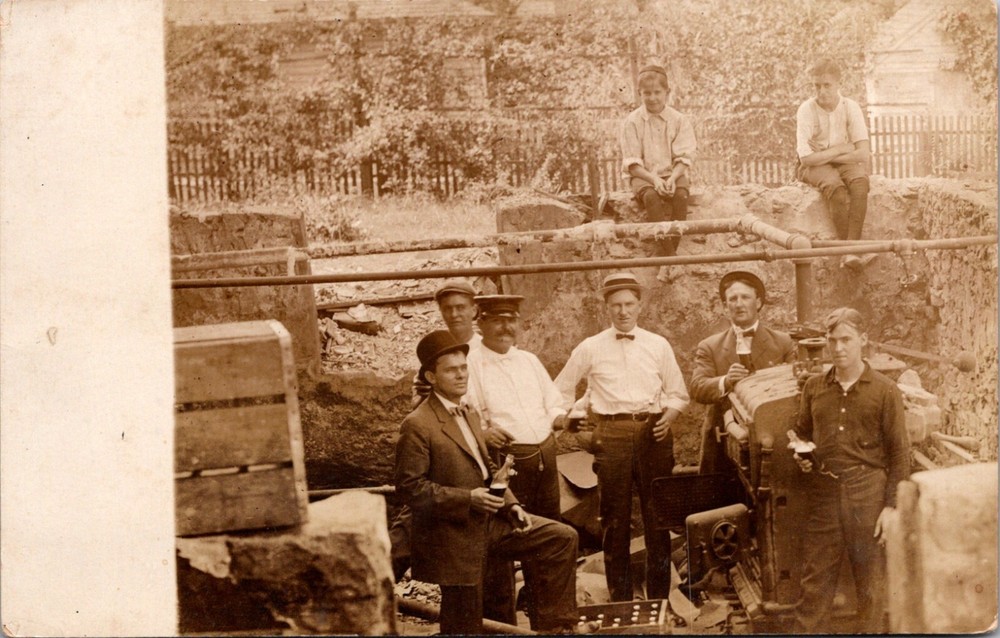 Group of Men Enjoy a Bottled Drink During an Excavation RPPC Postcard     16524