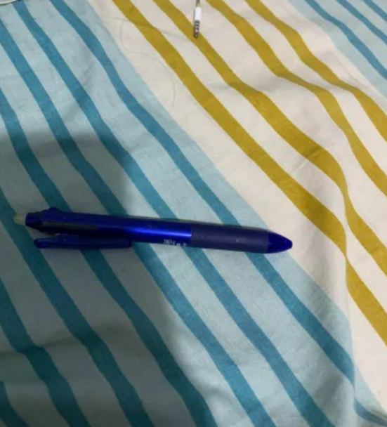 Blue ballpoint pen refill in pink without pocket