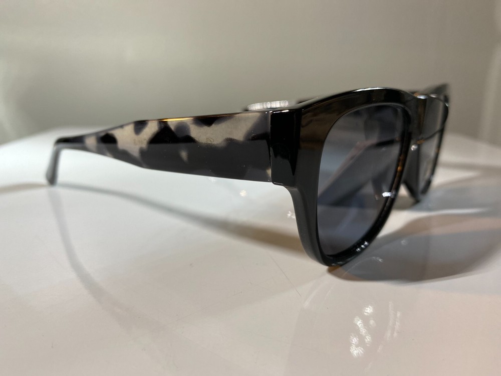 Women’s black frame marble sunglasses with blue tinted lenses