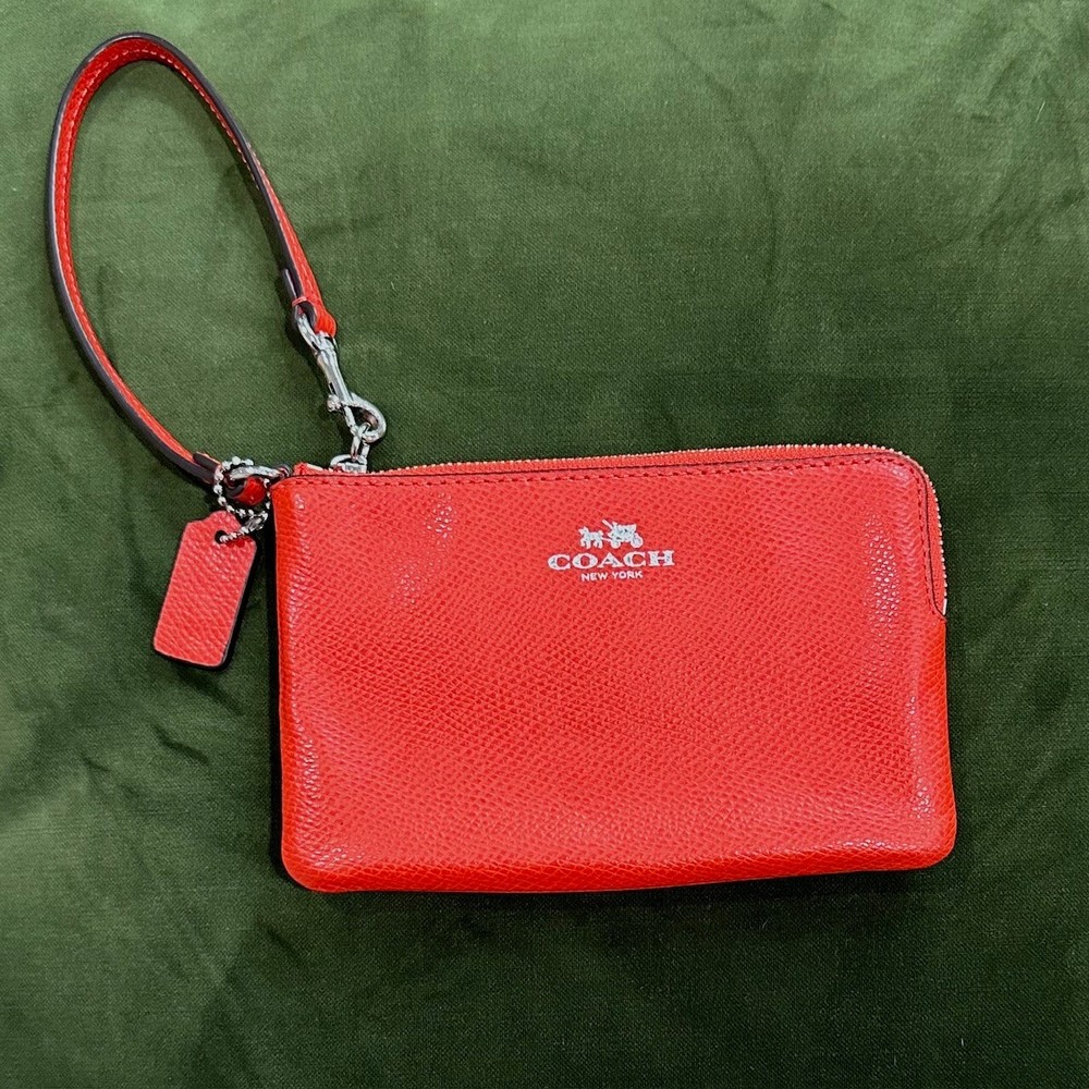 Coach Pebbled Leather Wristlet Wallet with Gold Accents in Vibrant Orange